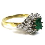 A 18ct gold, diamond and emerald ring, the central emerald cut emerald, 6 by 4.4mm, surrounded by