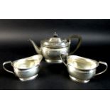 A George V silver bachelor's tea set, Atkin Brothers, London 1922, comprising a teapot with ebony