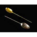 Two 18th century silver mote spoons, one with scroll piercings and engraved crest to oval bowl,
