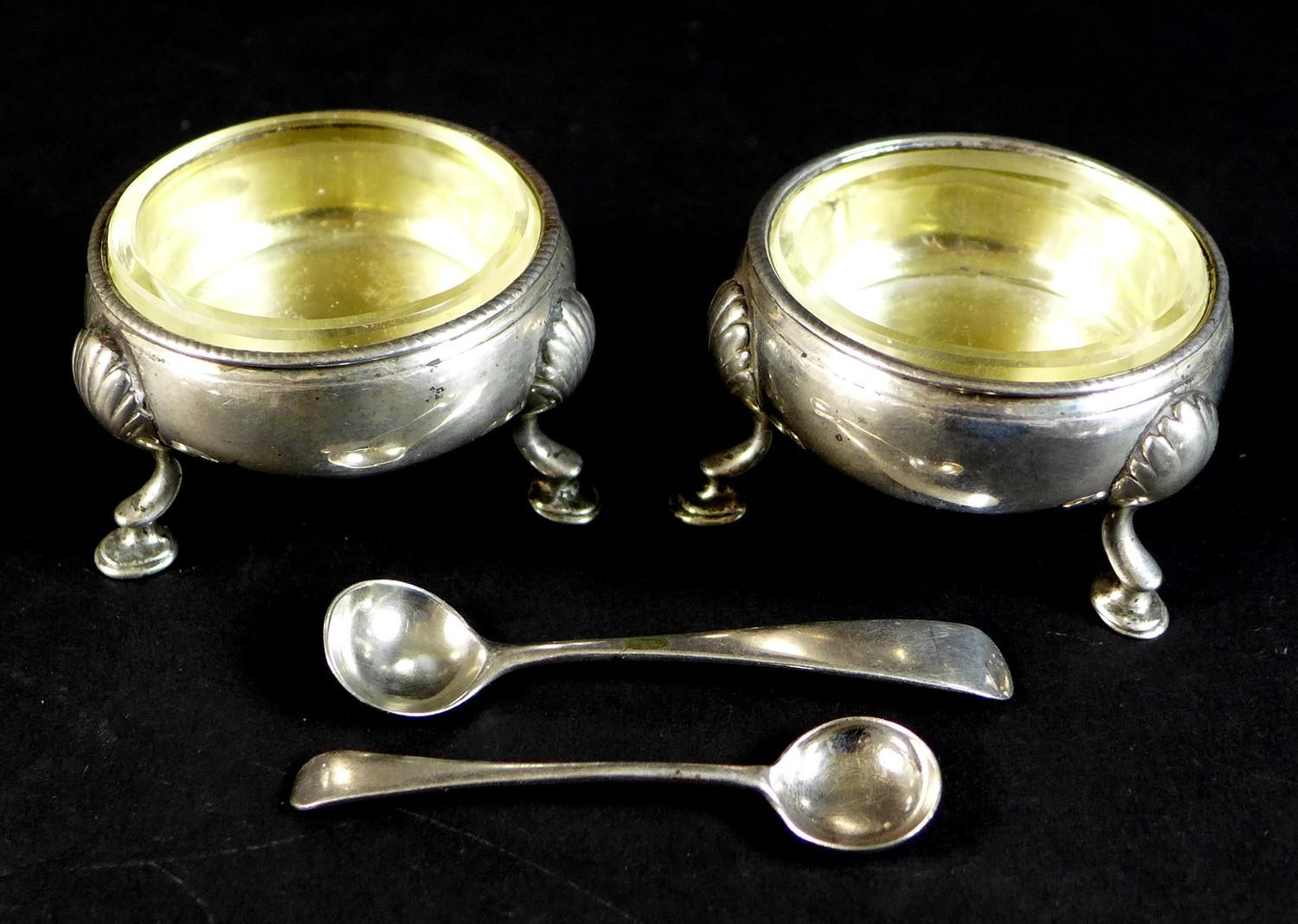 A pair of early George III silver cauldron salts, with parcel gilt interiors, both with engraved