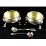 A pair of early George III silver cauldron salts, with parcel gilt interiors, both with engraved