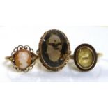 A group of three 9ct gold rings, comprising a citrine ring, size L, a cameo ring, size N, and a