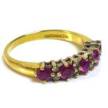 An 18ct gold ruby and diamond half eternity ring, set with five rubies interspersed with four