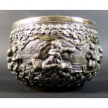An early 20th century Burmese white metal bowl, intricately repousse decorated and chased with a