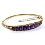 A 9ct gold amethyst and diamond bracelet of fixed hinged form, linearly set with nine graduated