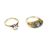 A 9ct gold, aquamarine and diamond ring, with three oval cut aquamarines, 7 by 5mm and 5 by 4mm,