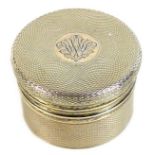 An Asprey George V silver gilt lidded box, cylindrical with machine engraved decoration, the lid