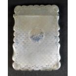 An early Victorian silver card case, with shaped outline, engraved C scroll and foliate decoration
