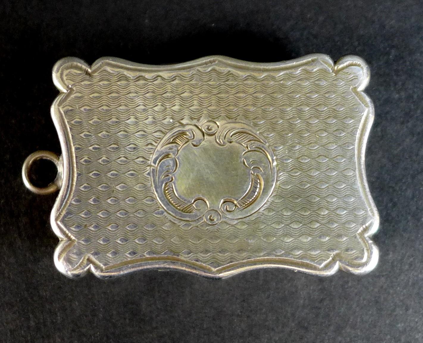 A Victorian silver vinaigrette, of shaped rectangular form, with wave engine turned decoration to - Image 2 of 7