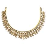 An 18ct gold and seed pearl fringed collerette necklace, likely 19th century, with quatrafoil and