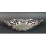 An Edwardian silver bowl, of oval form with scroll tips to each end and pierced decoration four