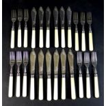 A set of Edward VII silver fish eaters, comprising twelve forks, 18.5cm, and twelve knives, 21cm,