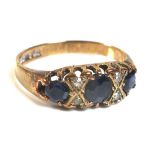 A 9ct rose gold, sapphire and diamond dress ring, set with three graduated sapphires,