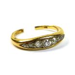 An 18ct gold and diamond seven stone ring, the old cut diamonds in a rub over setting, total diamond