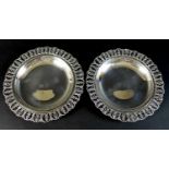 A pair of Egyptian silver graduated dishes, the pierced rims cast with repeating foliate pattern,