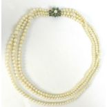 A simulated pearl triple strand necklace with 9ct gold turquoise and pearl clasp of starburst design
