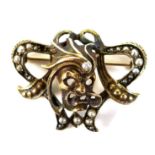 An unmarked yellow gold brooch, in Art Nouveau style with a central theatrical / operatic mask set