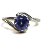 An 18ct white gold and solitaire tanzanite in a swirl setting, tanzanite approximately 6.9mm