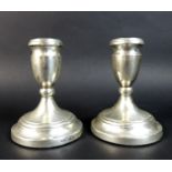 A pair of ER II silver dwarf candlesticks, with weighted bases, Roberts & Dore, Birmingham, 1980,