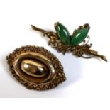 An early to mid 20th century 14ct gold butterfly brooch with jade wings 5.3cm wide, 5.3g, and a