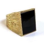 A 9ct gold gentlemen's ring, set with a rectangular cut and polished black stone, possibly jet, 19.5