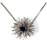 An 18ct white gold, sapphire and diamond starburst pendant brooch, the modernist design set with a