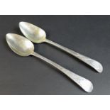 Two George III old English pattern silver table spoons, both with bright cut decoration, one with 'M