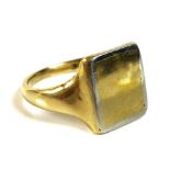 An 18ct gold signet ring, the rectangular field blank with white gold border, size R, 9.6g.