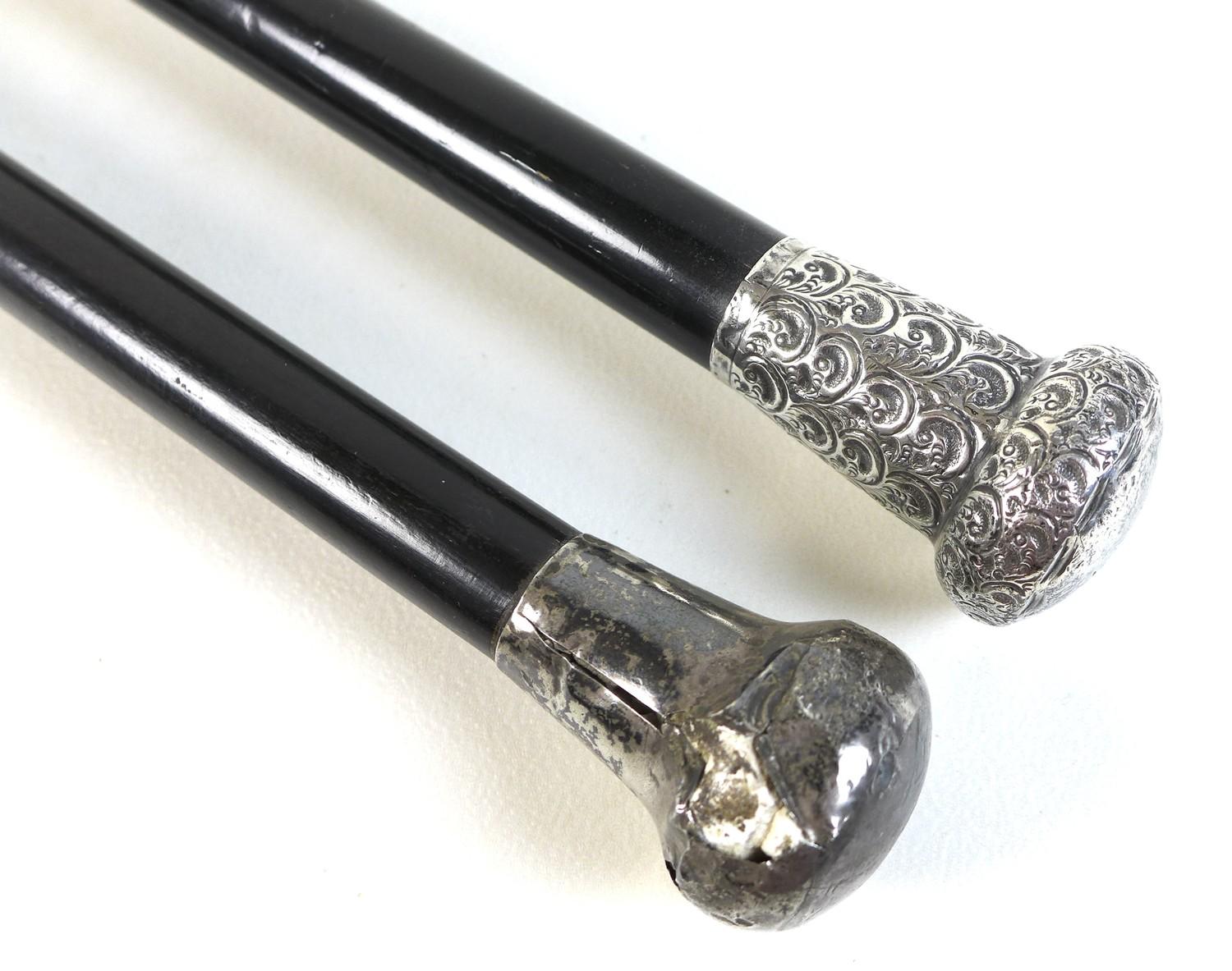 Two George V silver topped ebonised canes, one with a repousse wave patterned handle, and a silver - Image 2 of 6