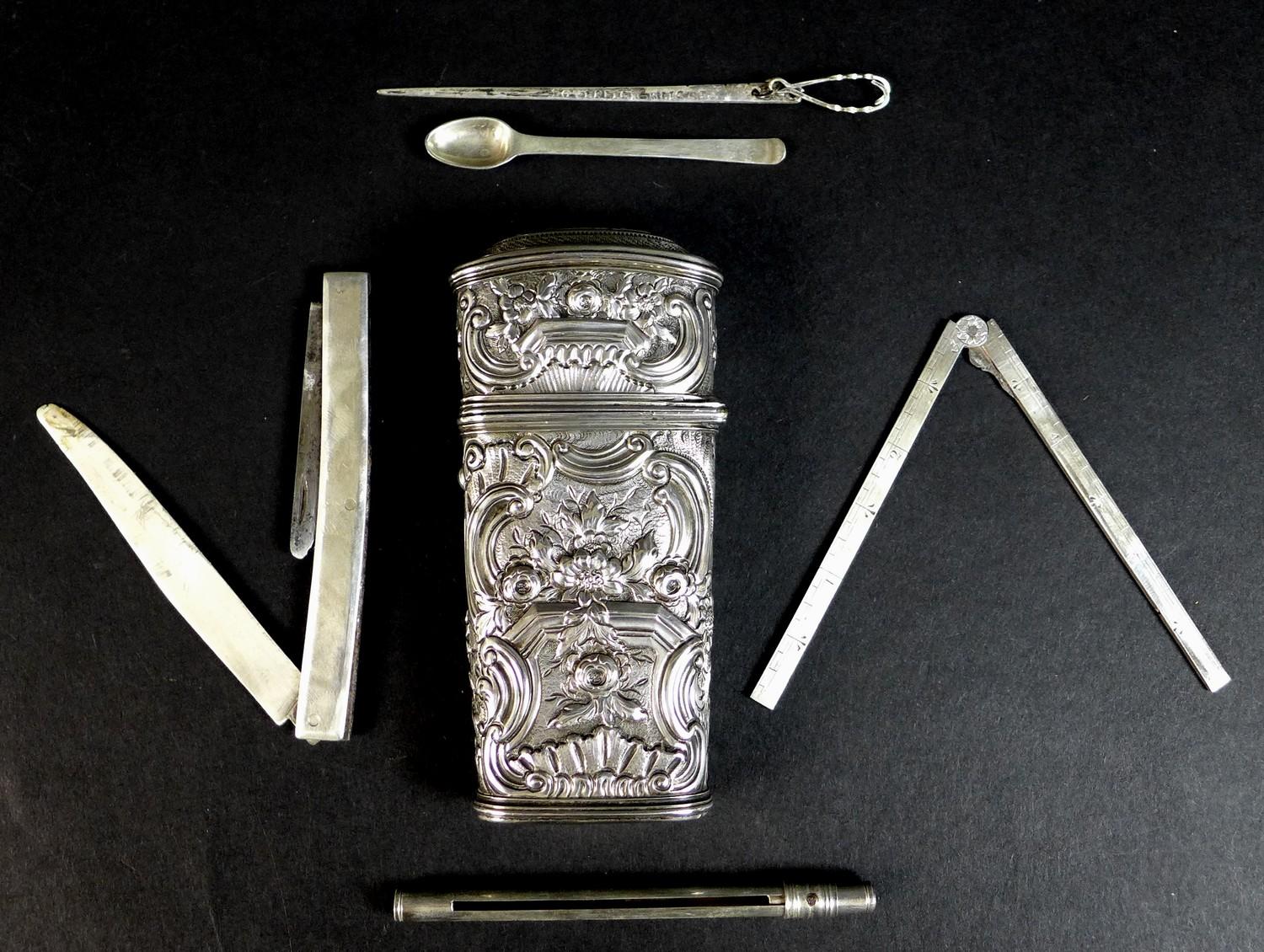 A late 18th or early 19th century silver coloured metal etui, of tapered rectangular form, chased