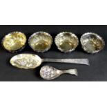 A group of Victorian and later decorative silver comprising four bonbon dishes, of swirl gadrooned