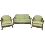 An Edwardian mahogany bergere three piece suite, comprising a three seater settee, 165 by 85 by 84cm