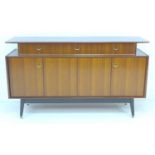 A retro G-Plan E. Gomme sideboard, circa 1958, tola and black sideboard, model T914, with three