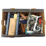 A collection of vintage tools, including planes, drills, gauges, jigs, punch sets, a chisel set, a