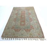 A modern Persian rug with cream ground, pale blue and pink floral decoration, end tassels tied in