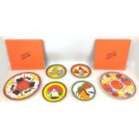A group of four Wedgwood Clarice Cliff Bizarre reproduction plates and two boxed chargers,