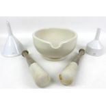 A large porcelain mortar, 23.5 by 28 by 13.5cm high, with two pestles, largest 28cm long and two