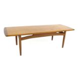 A retro G-Plan teak coffee table, circa 1970, 137 by 49.5 by 40cm high.