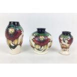 Three Moorcroft pottery Anna Lily pattern vases, all with impressed marks, to base with two of ovoid