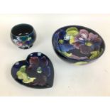 Three pieces of Moorcroft pottery, comprising, two clematis pattern pieces, a bowl, 16 by 7cm high