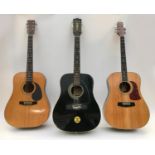 Three acoustic steel string guitars, comprising a 1970s Eko twelve string in black, an Aria SW20 six