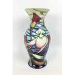 A Moorcroft pottery vase in slipper orchid pattern, of baluster form, with impressed marks, dated