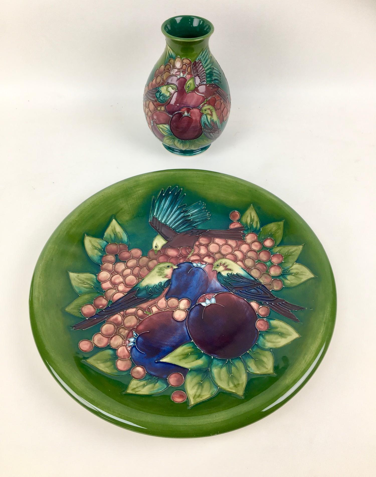 Two pieces Moorcroft pottery with finch and berry design by Sally Tuffin on green ground, comprising