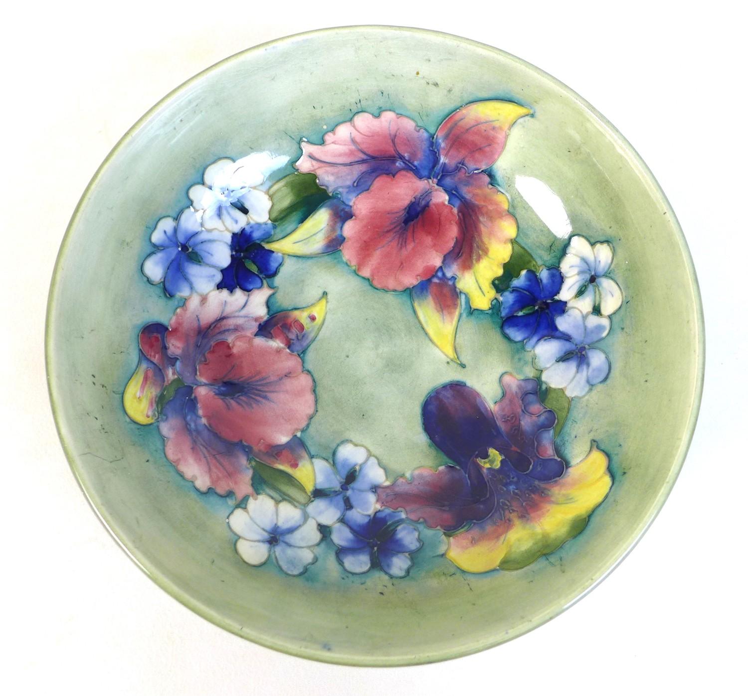 A Moorcroft bowl, the pale green ground decorated with Irises and blue violas, tublined and painted,