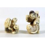 Two Japanese Meiji Period ivory katabori netsuke, one of a man playing with a child using a large