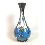 A Moorcroft pottery bottle vase in Rennie rose blue pattern, designed by Rachel Bishop with