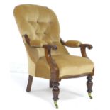 A Victorian spoon back armchair, buttoned pale pink velvet upholstery, scroll arm with padded