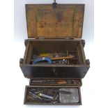 A wooden tool chest, containing a variety of hand tools, together with a further box containing hand