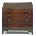 An early 19th century mahogany bureau, fall front with fitted interior, over four graduating drawers