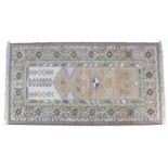 A modern Pakistani prayer rug, with cream ground, pale orange, green and brown geometric decoration,